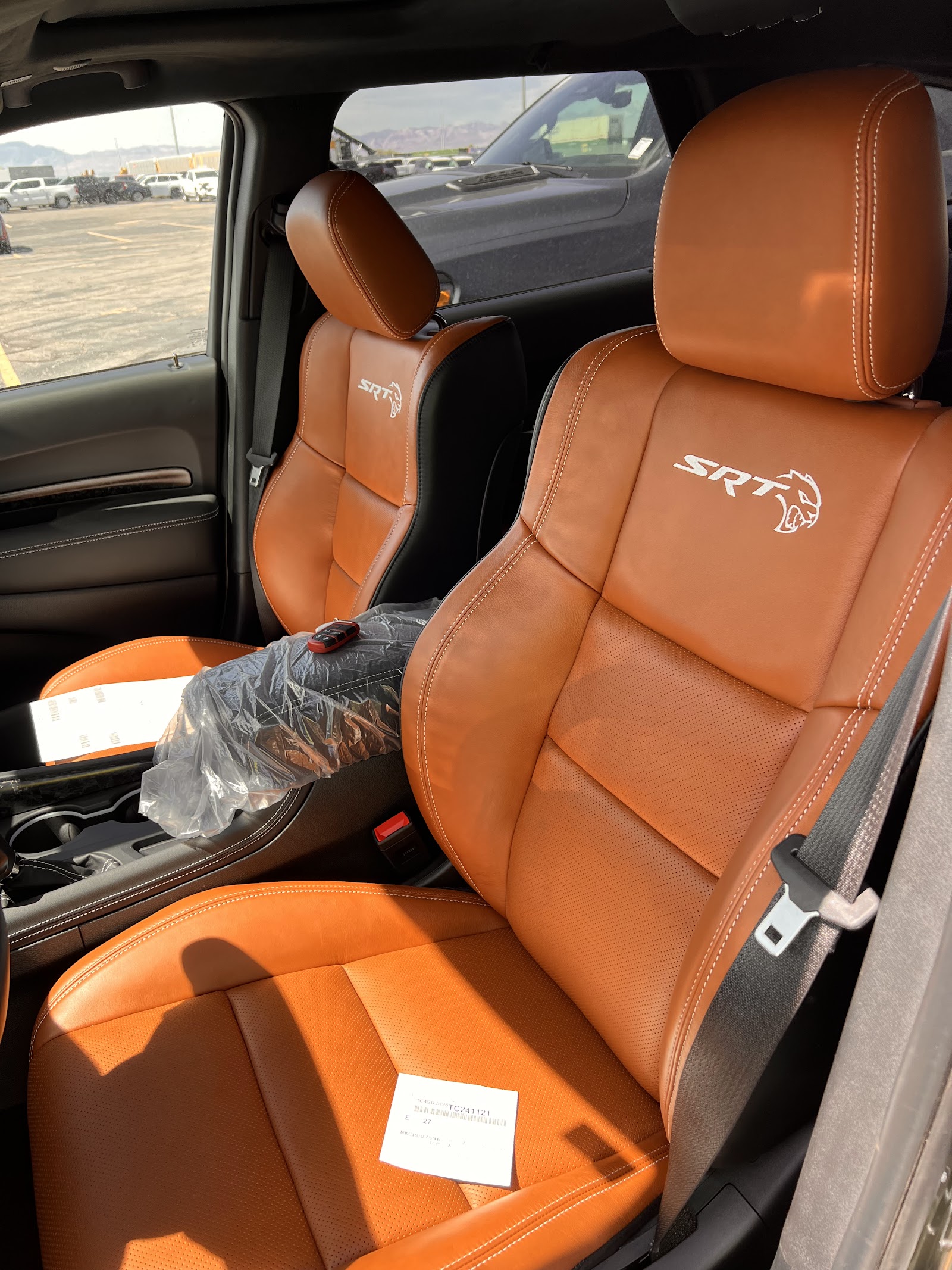 Orange and black SRT leather seats inside a Dodge or Jeep vehicle